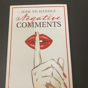 A book cover with a hand and lipstick on it.