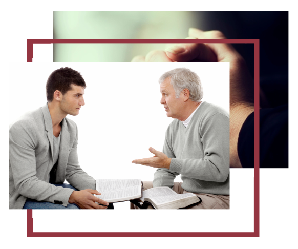 Two men are sitting at a table talking.